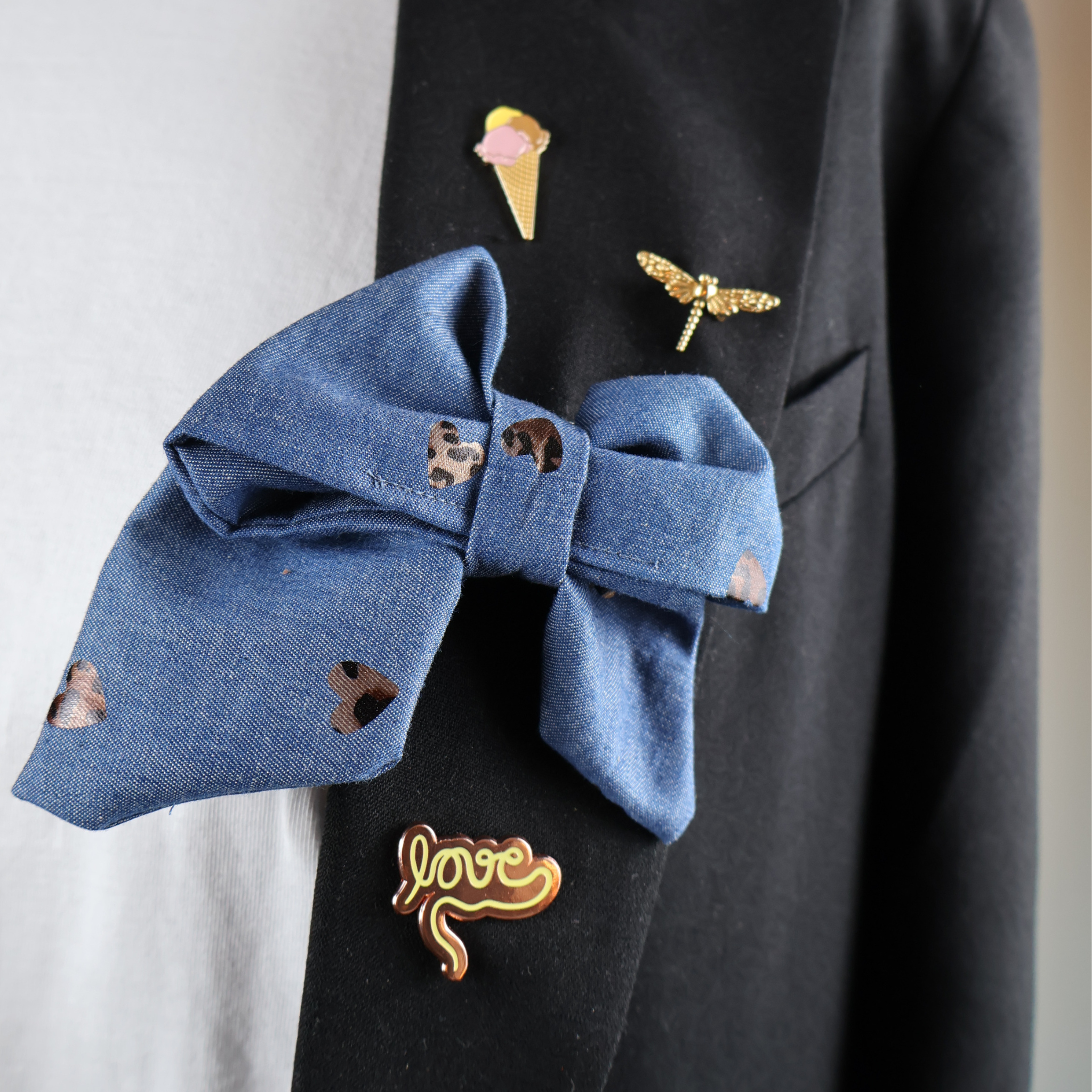 Denim fabric bow tie with panther hearts and safety pin