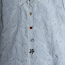 Button covers gold, silver, red on white blouse