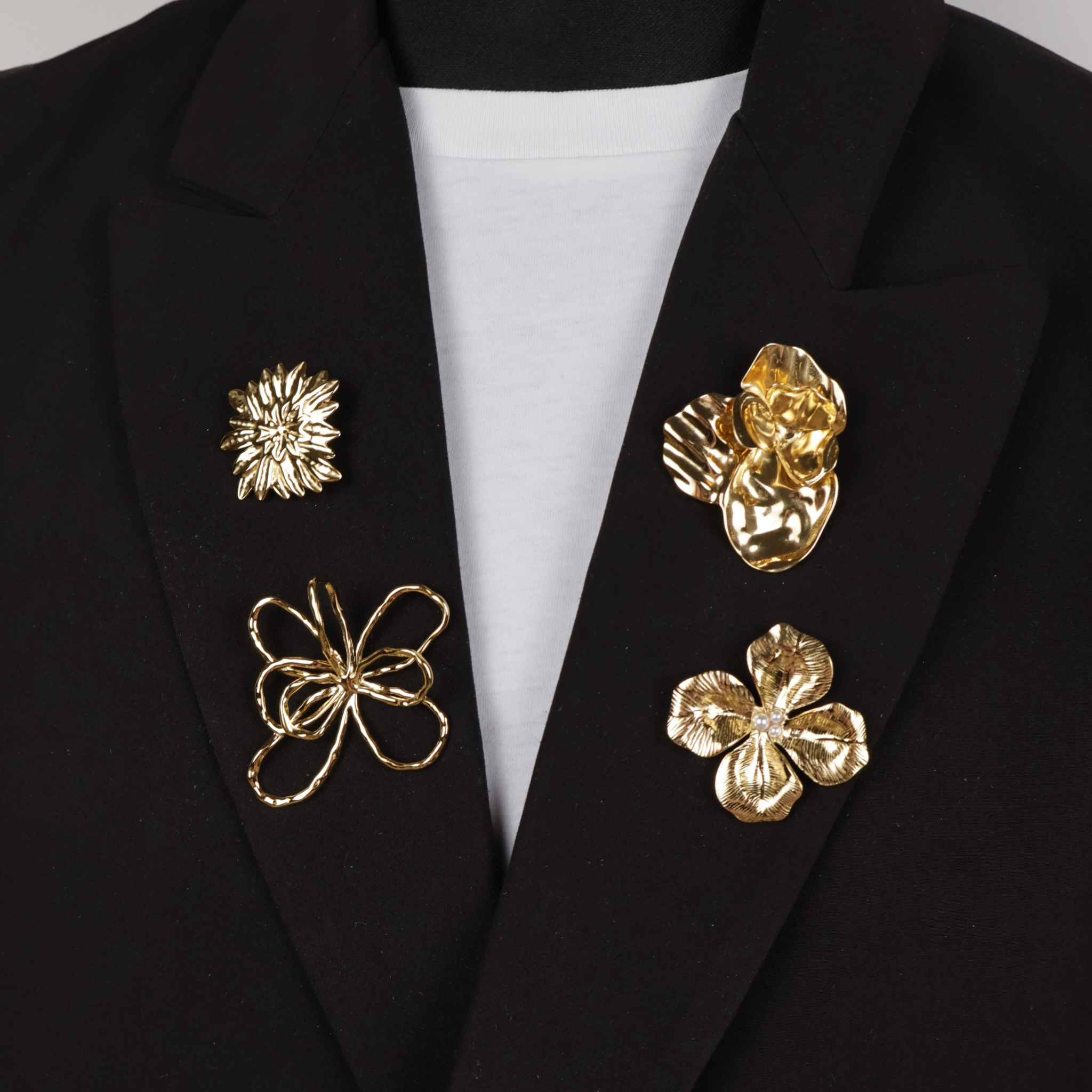 Brooches and pins on black blazer
