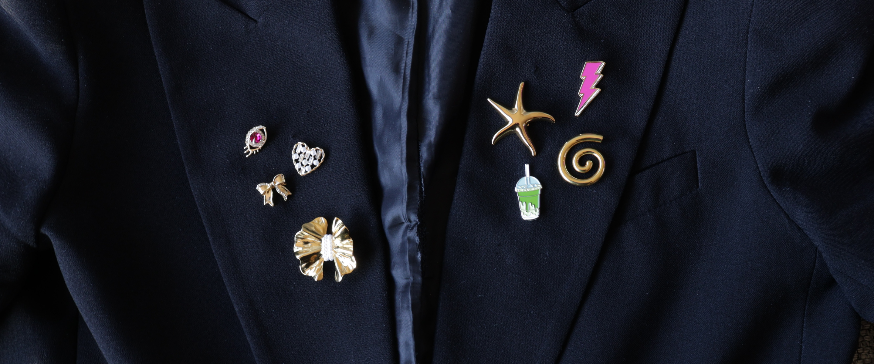 Header_home_brooches_and_pins_on_black_blazer