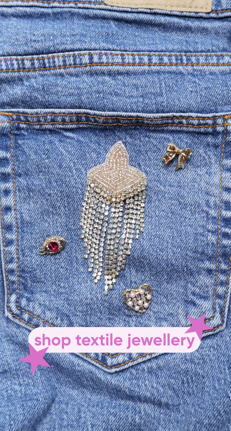 Brooch and pin on blue jeans