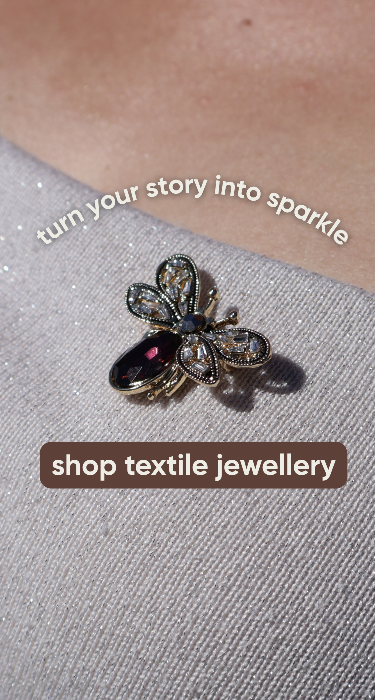 red butterfly brooche on sparkling woman top